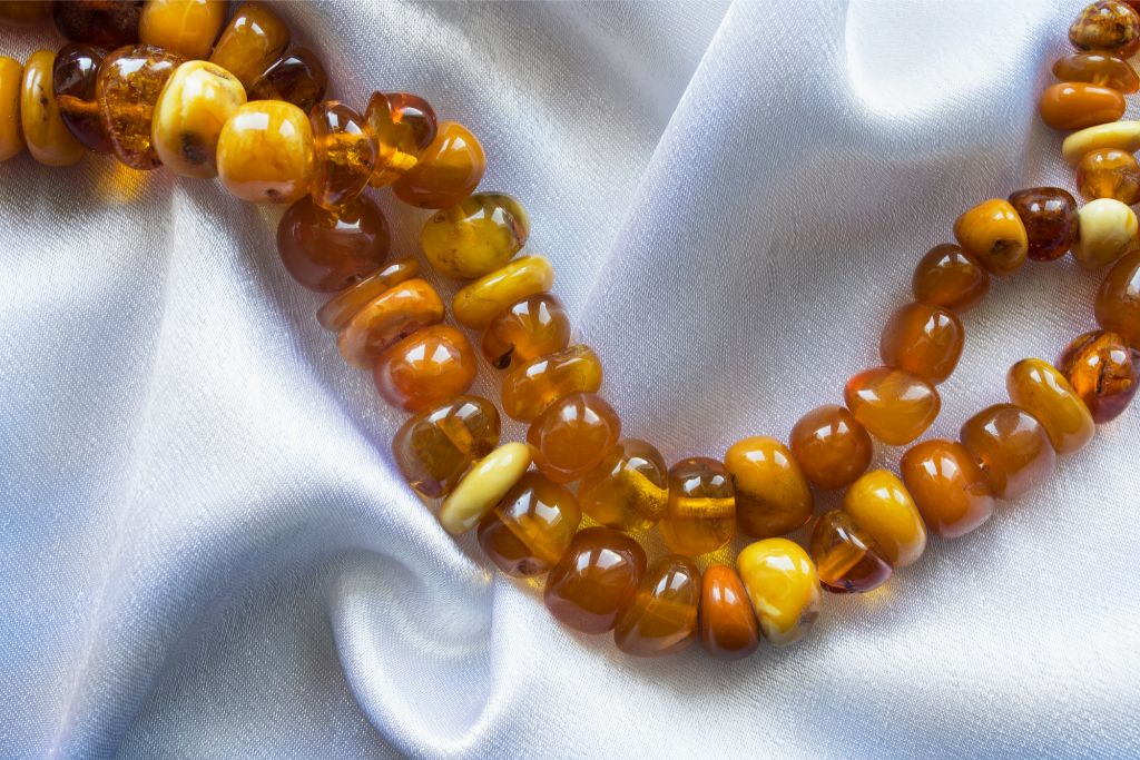 amber with pressed amber bracelet beads situated on a piece of white fabric
