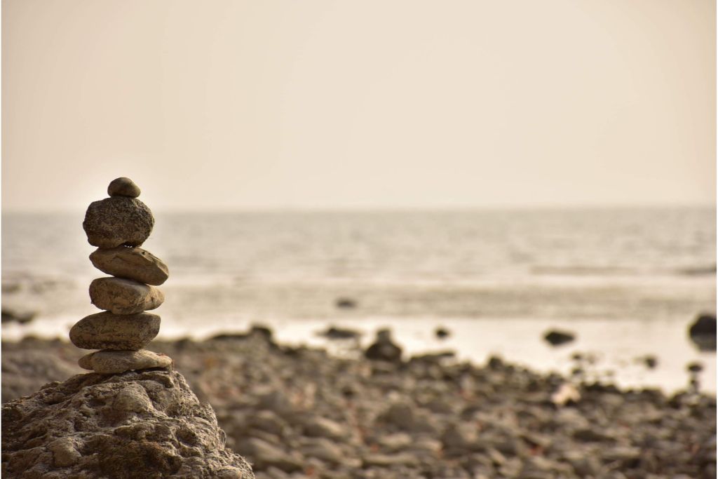 balanced piled-up stones near the ocean