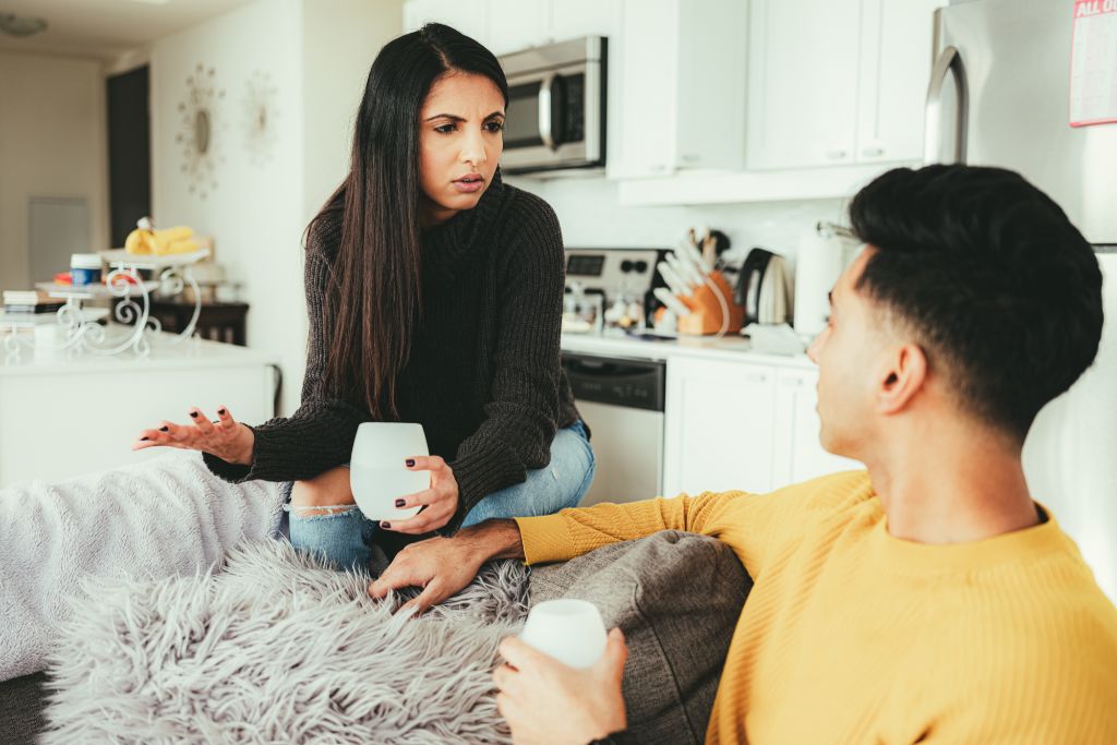 Two person talking intensely while holding a cup