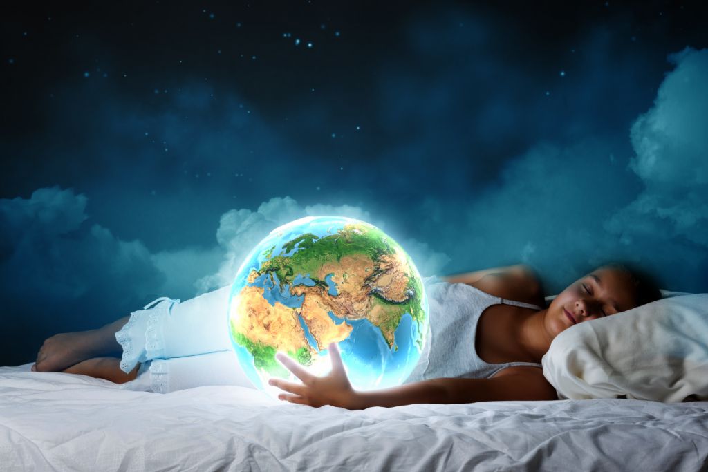a woman sleeping while holding an edited earth planet on her hand