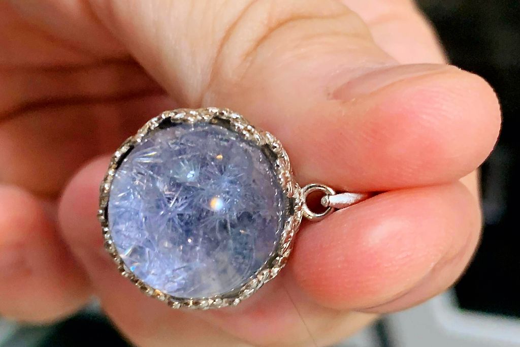 dumortierite quartz ring on womans left hand