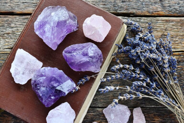 Lavender flowers near a group of amethyst rocks.