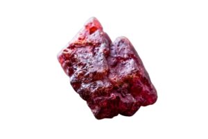 rough red spinel on white background