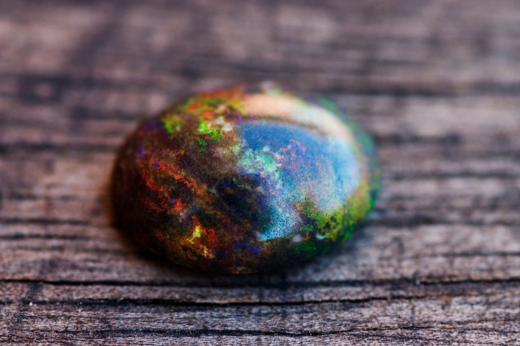 Black opal on wooden surface