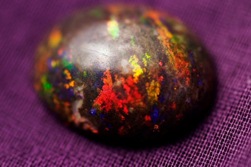 black opal on purple surface