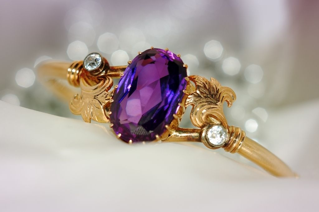 gold ring with diamond and purple sapphire
