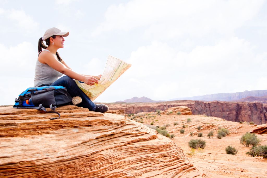 girl sitting on the grand canyon depicting a great adventure