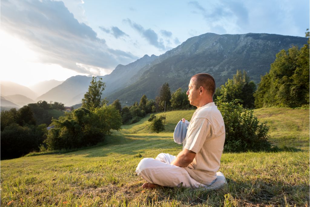 man sitting doing maha mantra