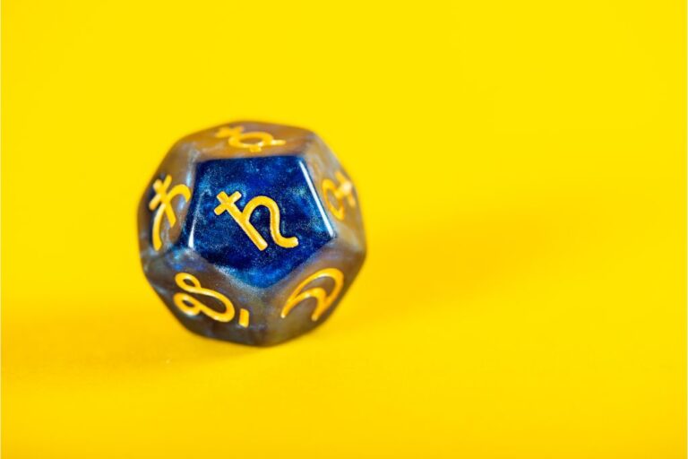 saturn symbol on a dice with yellow background