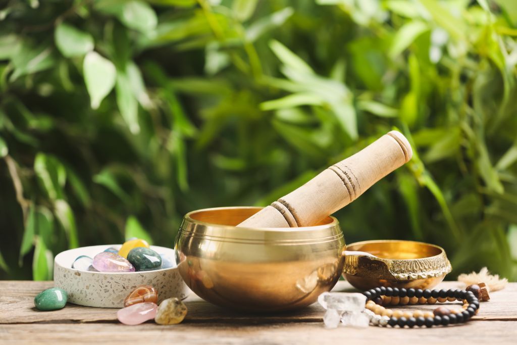 singing bowl surrounded by nature and crystals