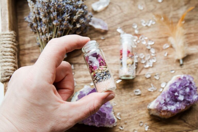 hand holding a jar with crystals