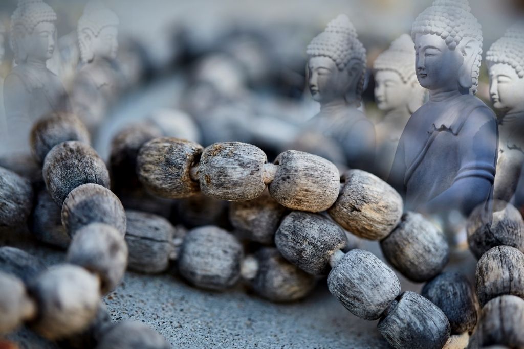 weathered prayer beads with meditating buddha depicting spirit guides