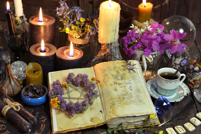 A spell set-up with candles, herbs, and crystals