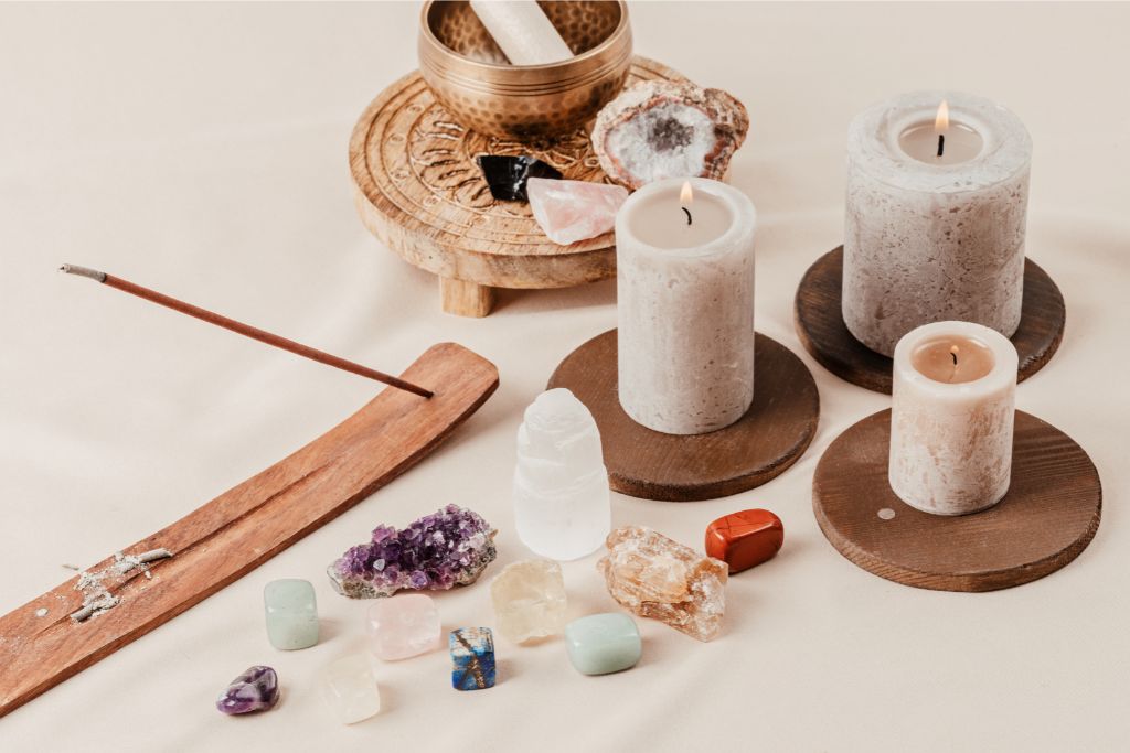 stones, candles and singing bowls on a clean, tranquil surface depicting balance altar