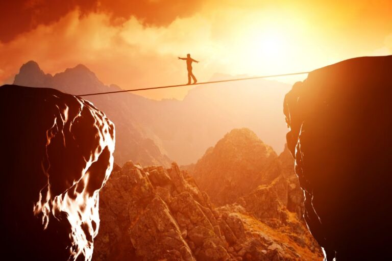 man walking and balancing on a rope depicting bravery