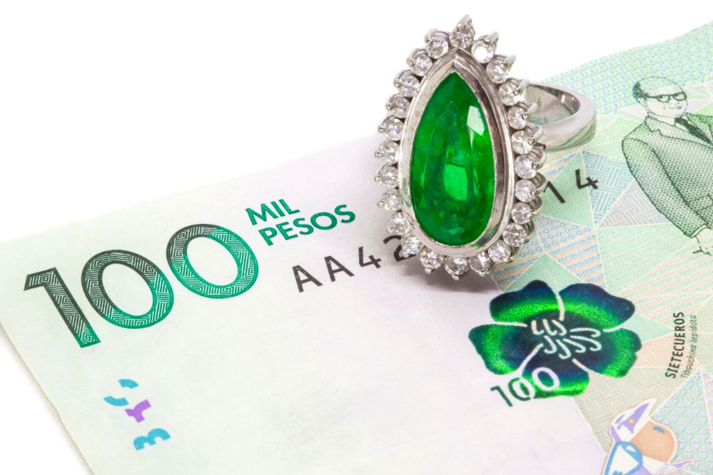 colombian emerald ring on top of money