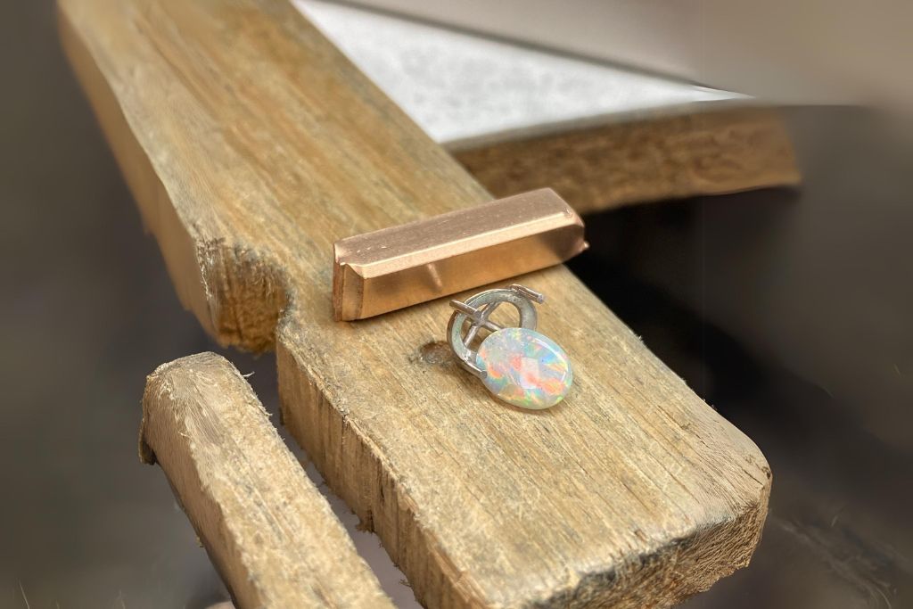 harlequin opal on a wood surface