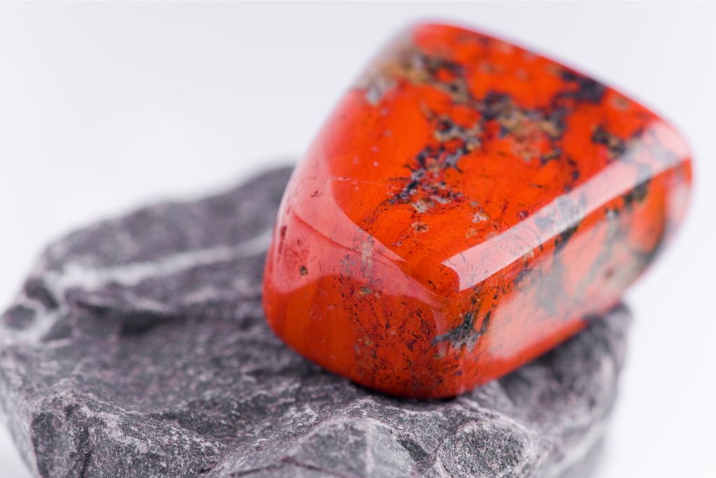 poppy jasper situated on rough rock like platform