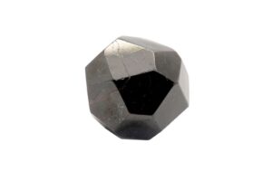 semi polished melanite garnet on white background