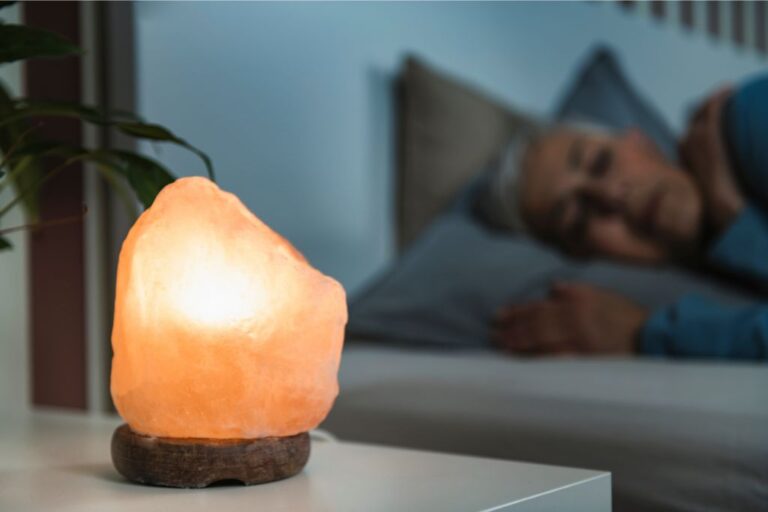 woman sleeping with a himalayan salt lamp