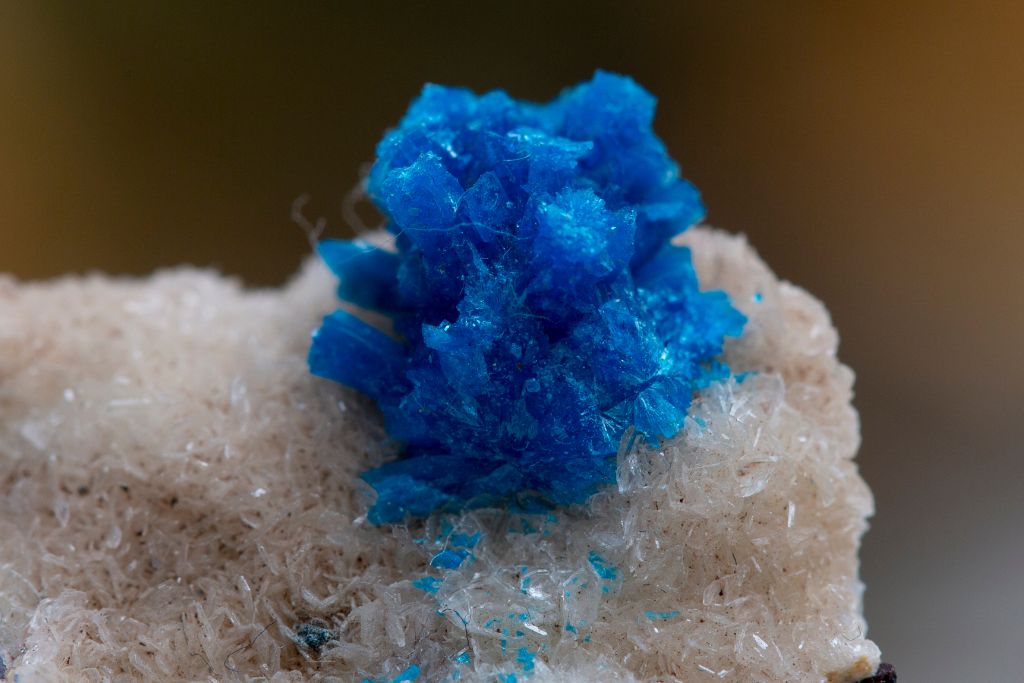 Aurichalcite crystal on a white-colored clustered crystal