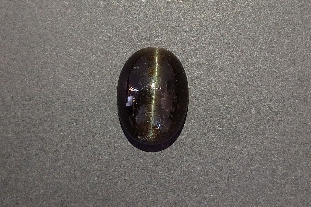 Cat's Eye Quartz on a grayish surface