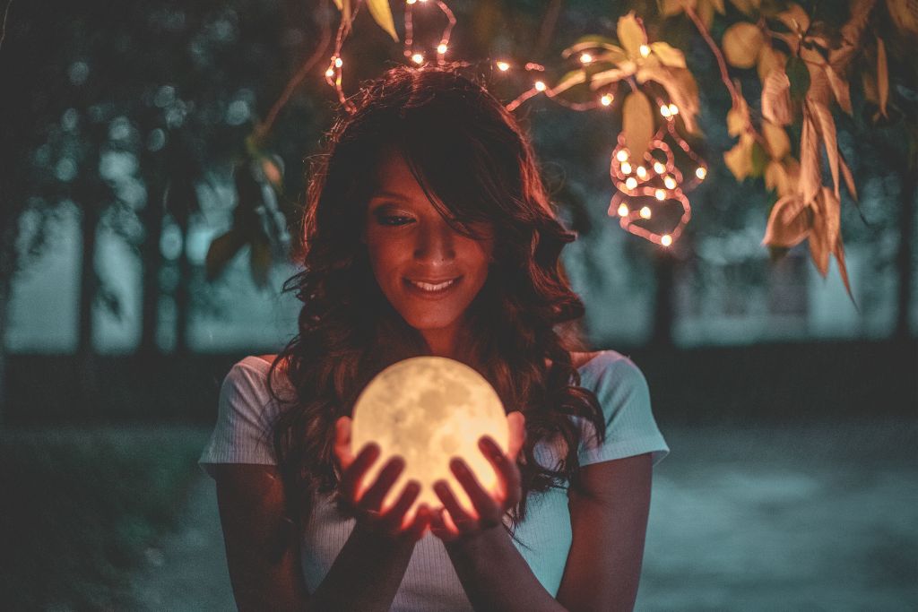 a woman holding a moon