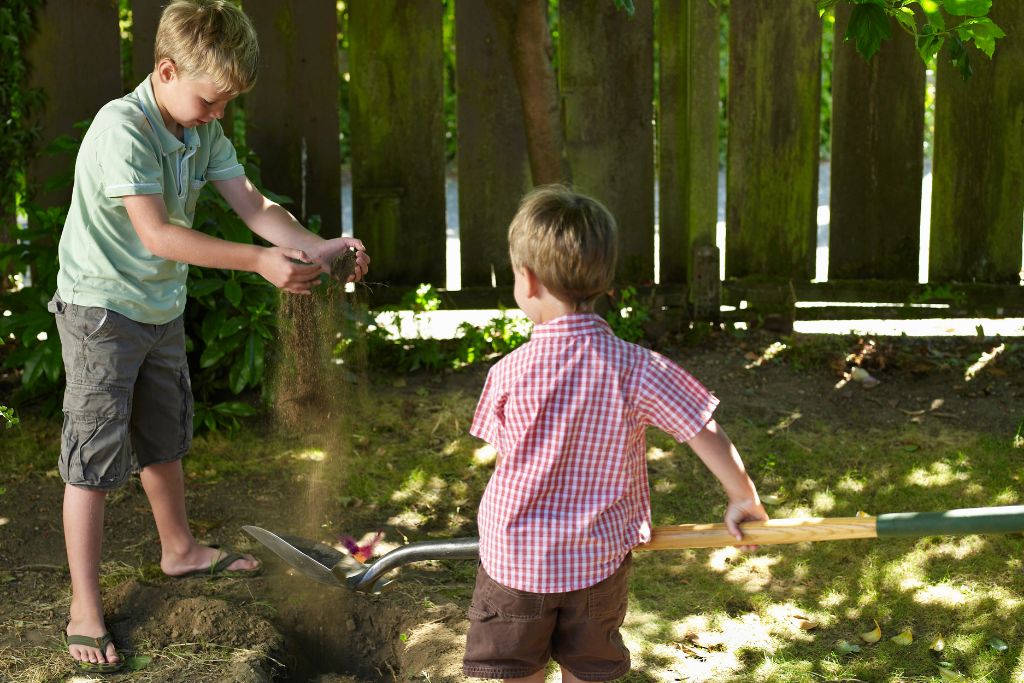 Two boys burying crystal