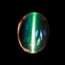 cat's eye tourmaline on dark background