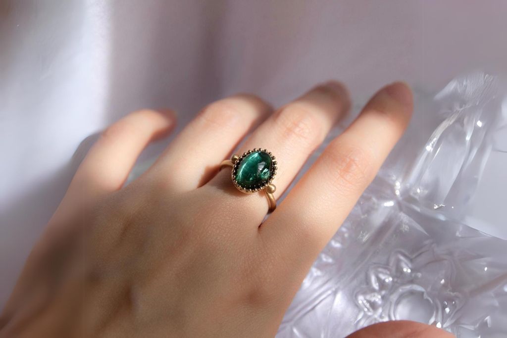 cat's eye tourmaline ring worn on a hand