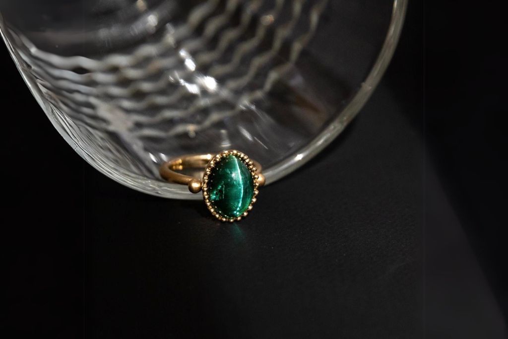 cat's eye tourmaline ring on a glass