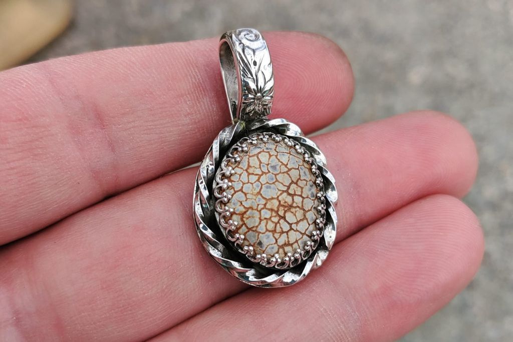 snakeskin agate pendant on owners hand