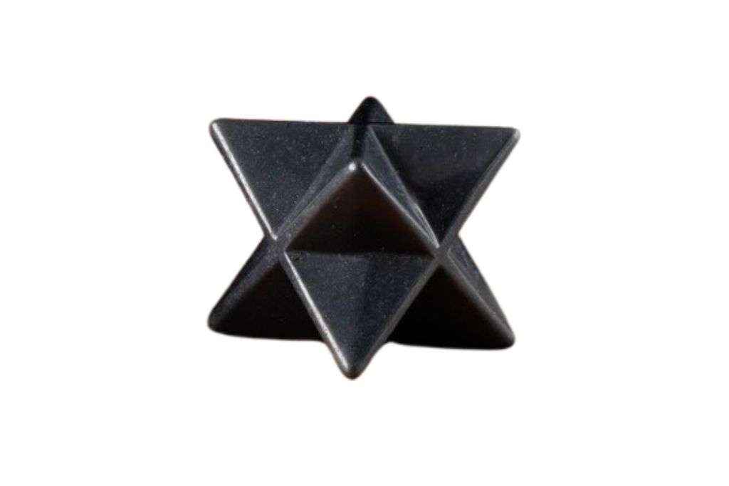 Merkaba star shaped Hematite on a white background