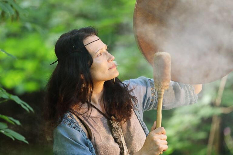 woman shaman playing on drums