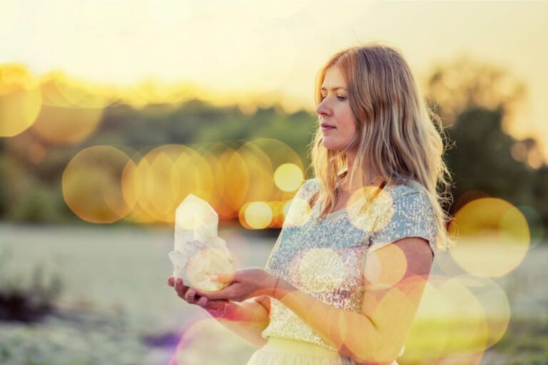 a woman holding crystals in nature