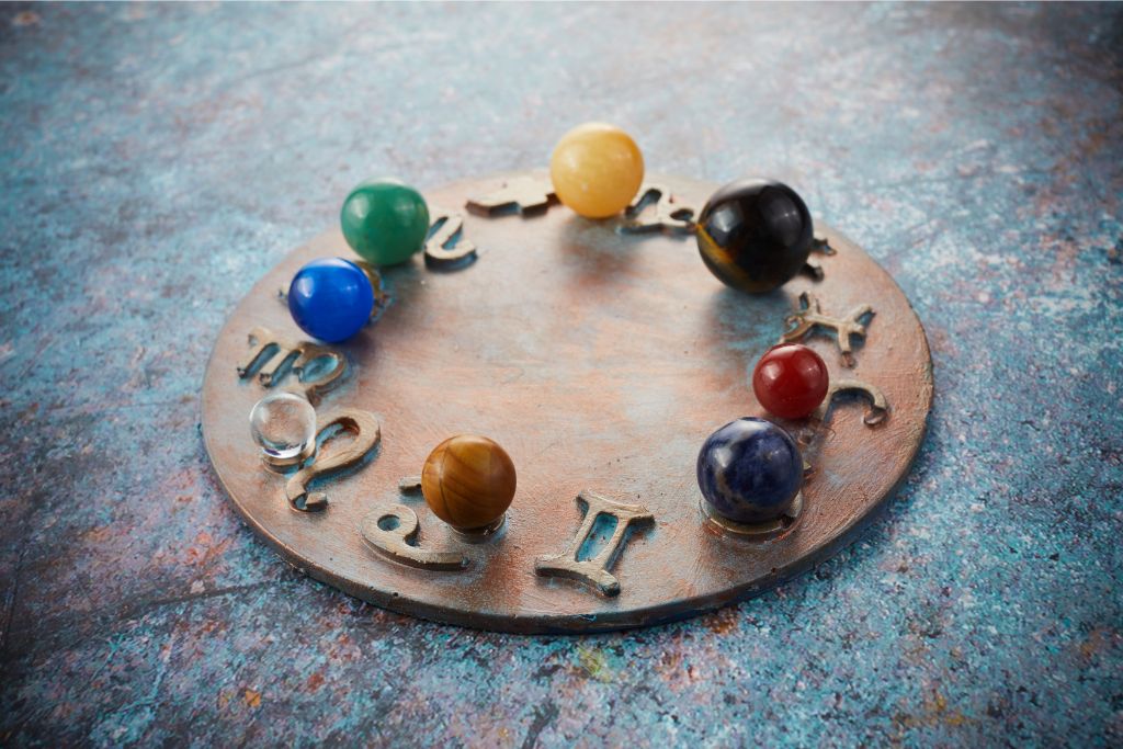 Horoscope symbols with marbles representing planets