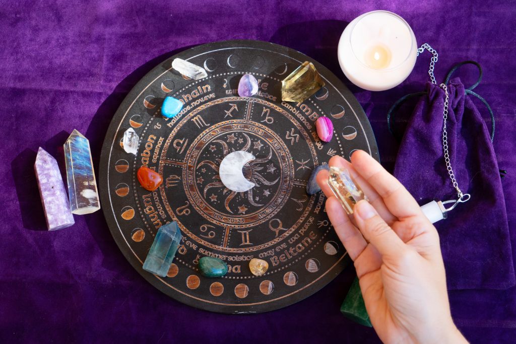 astrology wheel with crystals on velvet background
