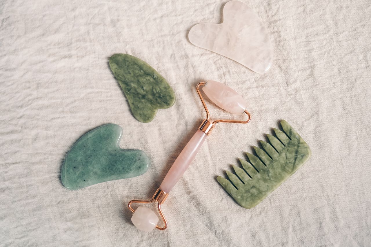 various crystal beauty accesories on a white cloth