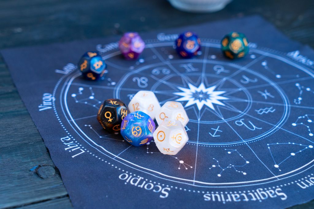 divination dice on a zodiac chart