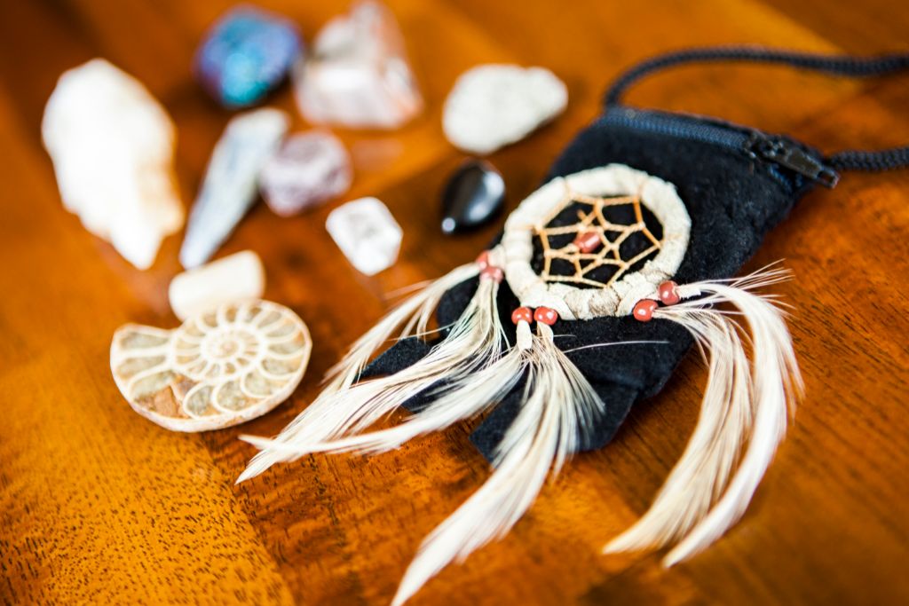 dreamcatcher and crystals on wooden background