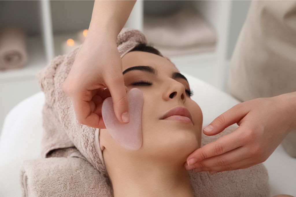 woman having a face massage with crystal gua sha