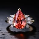 padparadscha sapphire ring on dark background