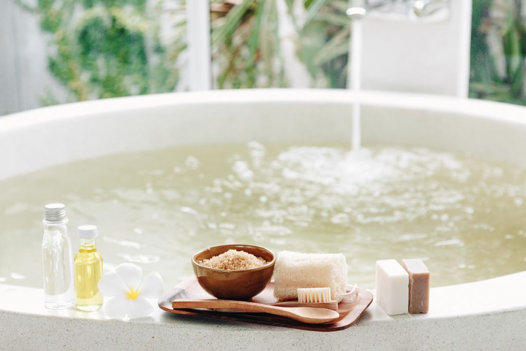 bath tub filled with bath essentials