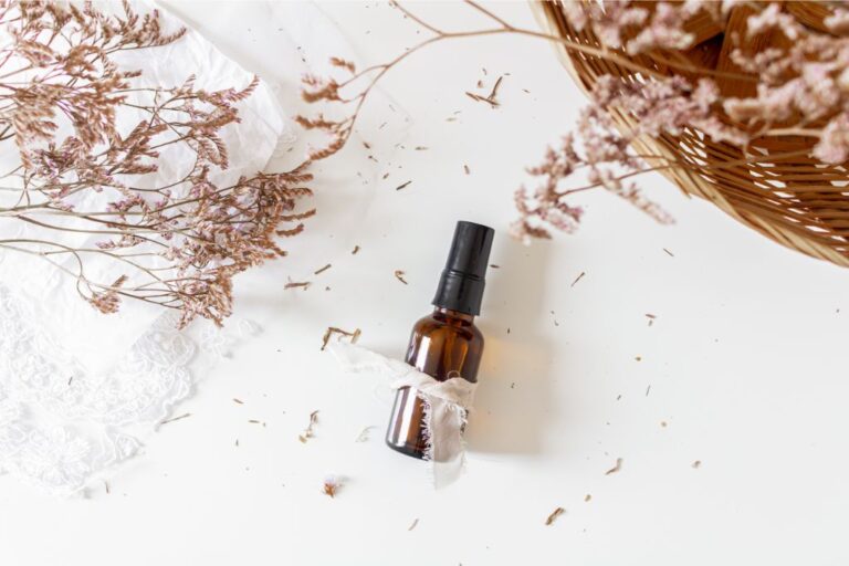 spray bottle on white background with dried flowers