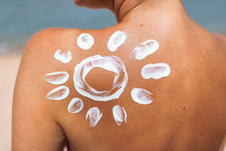 woman's back with spf lotion in the shape of the sun