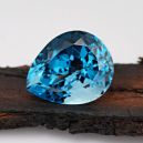 swiss blue topaz on burnt wood plank