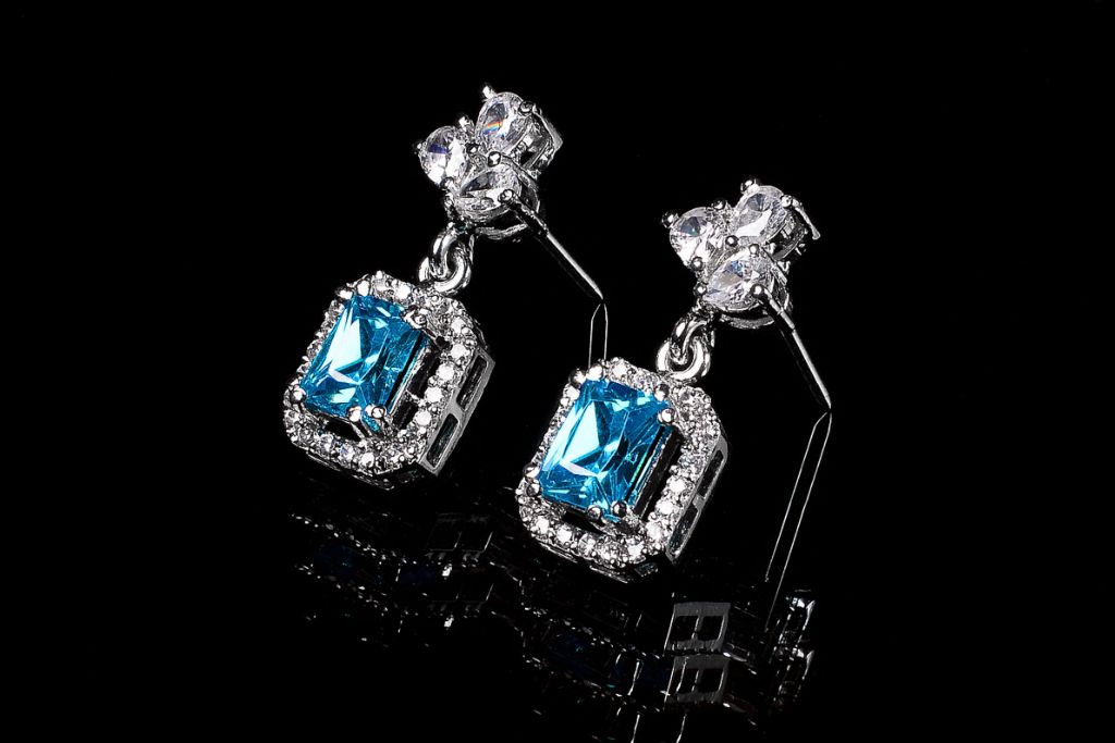 swiss blue topaz silver earring on dark background